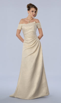 A model wears a champagne-colored Long Formal Dress: Stella Couture 26373, featuring a floor-length design with an off-the-shoulder crossover bodice and a draped skirt.