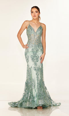 A woman wears the Cecilia Couture 2641 long prom dress, featuring a fitted mermaid silhouette with green sequin embellishments and a sheer corset bodice, looking directly at the camera.