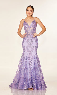 A woman poses with hands on hips in the Cecilia Couture 2641 long prom dress, a fitted, floor-length lavender mermaid gown with thin straps and floral sequin embellishments, set against a plain backdrop.