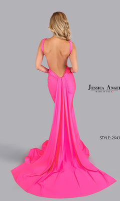Woman in an open-back long prom dress, Jessica Angel style 2643, featuring a bright pink hue and sweeping train, poses against a plain gray background.