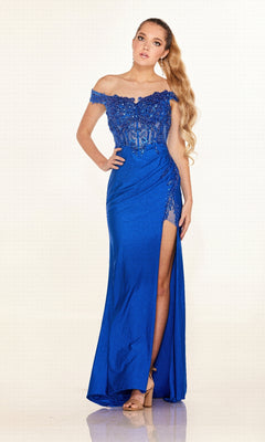 A woman models the Cecilia Couture 2645 long prom dress in royal blue, showcasing off-the-shoulder lace details, a thigh-high slit, and an elegant lace-up back against a plain light background.