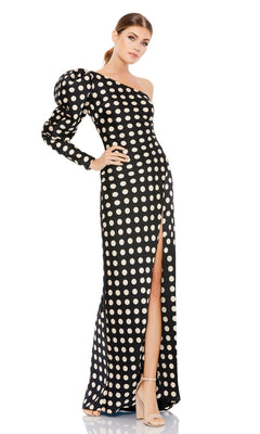 A woman wears the Long Formal Dress 26515 by Mac Duggal—black and white with white polka dots, off-shoulder, one puffed long sleeve, thigh-high slit—paired with nude high-heeled sandals.