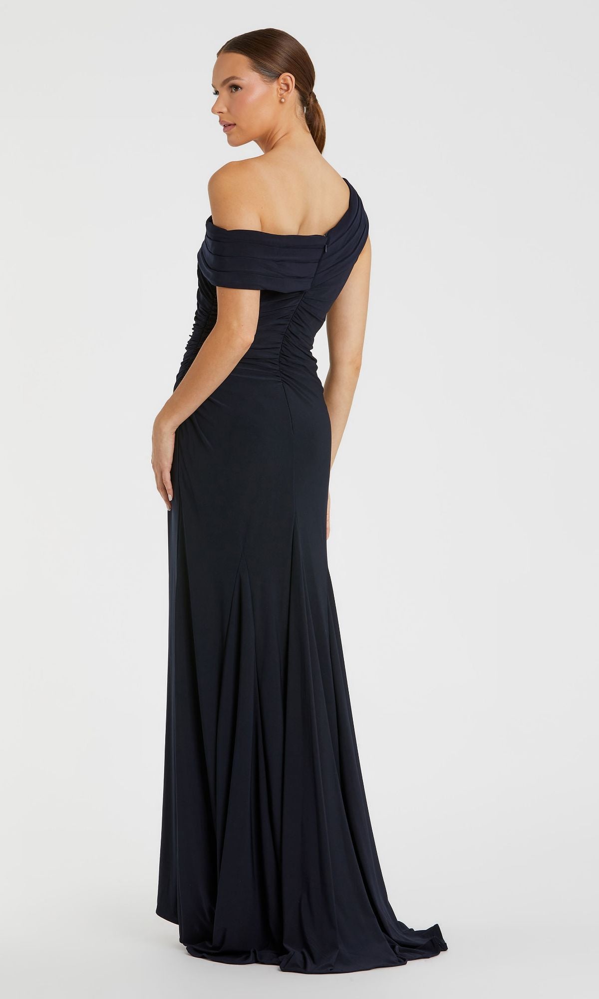 Woman wearing the Mac Duggal 26517 one-shoulder long prom dress, standing with her back to the camera against a plain white background.