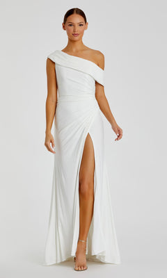 Woman models the Mac Duggal 26517, a white, one-shoulder long prom dress with a floor-length silhouette and thigh-high slit, standing against a plain background.