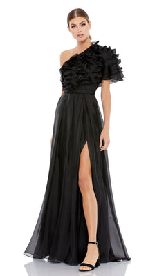 A woman wears the Mac Duggal 26527, a one-shoulder black formal dress with ruffles, a high waist, and a thigh-high slit, stylishly paired with black high-heeled sandals.