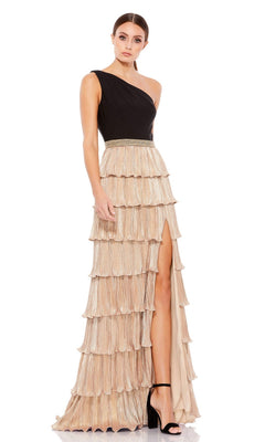 A woman wears the Black and Gold Long Formal Dress: Mac Duggal 26541, featuring a one-shoulder black top, gold tiered pleated skirt with a thigh-high slit, paired with black high-heeled sandals.