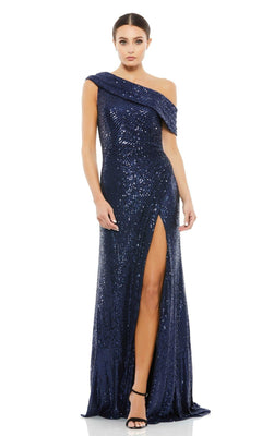 Woman in a navy blue Mac Duggal 26550 Drop-Shoulder Sequin Formal Gown with thigh-high slit and black heels, posing against a white background.