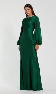 A woman stands against a plain white background wearing the Mac Duggal 26575, a long sleeve formal dress in emerald. Featuring a fitted bodice and slightly flared skirt, this modest evening gown radiates timeless elegance and sophistication.