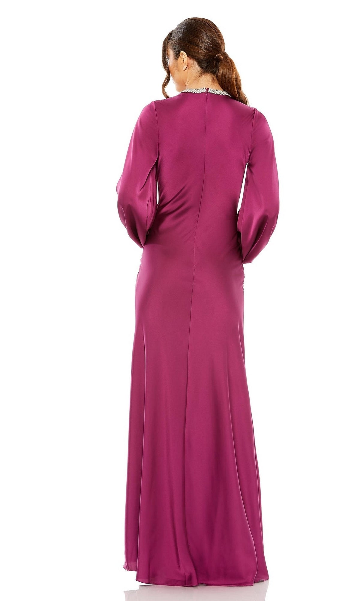 A woman stands facing away, wearing the Mac Duggal 26575 long sleeve formal dress in magenta, featuring a subtle sheen and a classic straight evening gown silhouette.