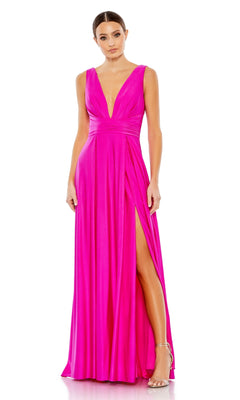 A woman wears the Mac Duggal 26578 V-Neck Long A-Line Prom Dress in bright pink, featuring a sleeveless design, deep neckline, and high slit, styled with strappy heels.