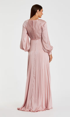 A woman, seen from behind against a white background, wears the Mac Duggal 26590: a pleated long formal dress in elegant light pink satin with long sleeves and a high waist.