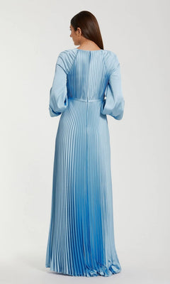 Woman wearing the Mac Duggal 26590 long sleeve formal dress with light blue pleats, standing and facing away from the camera against a plain background.