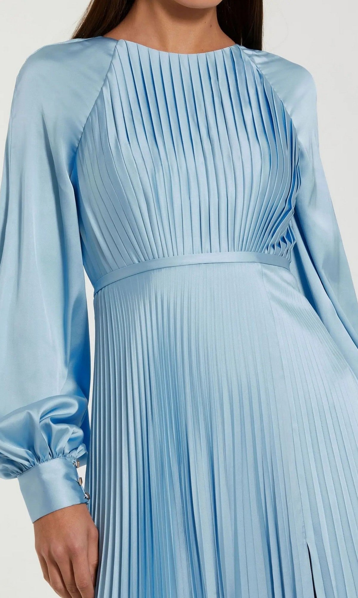 A woman wearing the Mac Duggal 26590, a light blue long sleeve formal dress featuring pleats, a fitted waist, and round neckline.