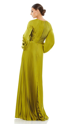 Woman stands facing away, her hair in a low bun, wearing the Mac Duggal 26590 Long Sleeve Long Formal Dress—floor-length and pleated—against a white background.