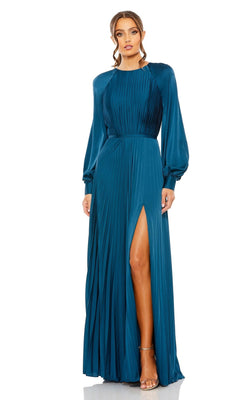 A woman stands against a plain white background wearing the Mac Duggal 26590: a teal pleated long formal dress with long sleeves and a high slit.