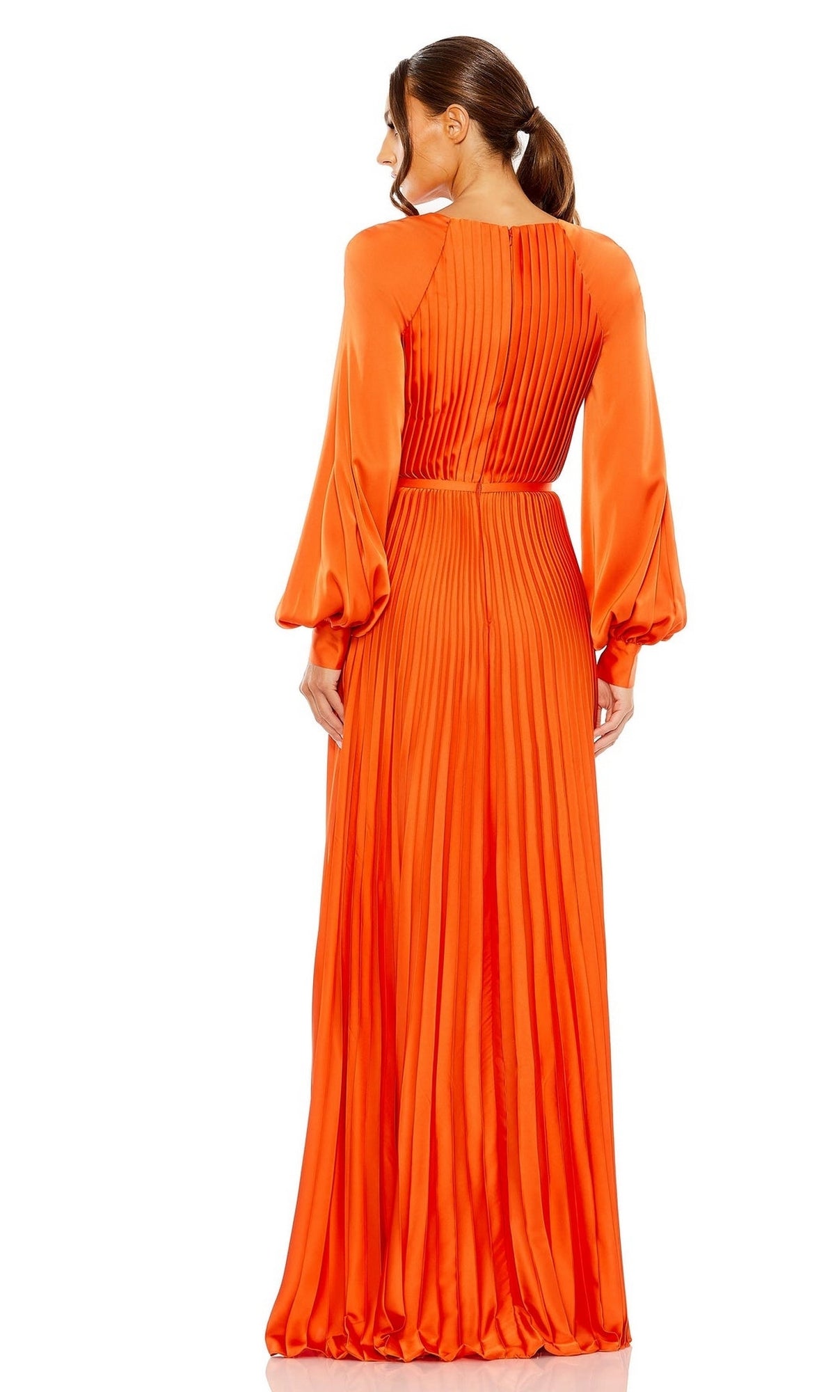 Woman models the Mac Duggal 26590, a pleated orange long formal dress with long sleeves, viewed from the back. Her low ponytail completes this chic and modest look—ideal for prom or any elegant occasion.