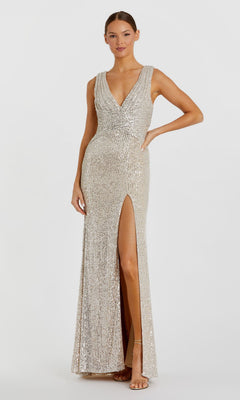 A woman wearing the Mac Duggal 26598 Sleeveless Long Formal Dress, featuring silver sequins, a deep V-neck, and a high leg slit, stands against a plain white background.