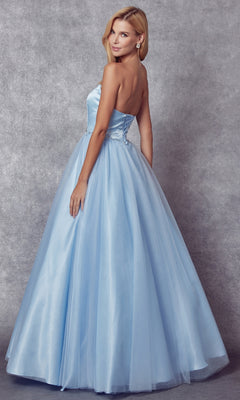 A woman stands slightly turned to the side against a gray textured background, modeling the Strapless Sweetheart Long Prom Ball Gown 265 with a corset-style back.