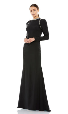 A woman poses elegantly in the Mac Duggal 26612 long sleeve black formal gown, adorned with jeweled accents on the shoulders and neckline, against a white background.