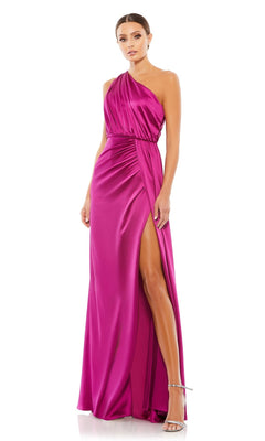 Woman wearing the Mac Duggal 26654 one-shoulder long formal dress in magenta satin with an asymmetrical neckline and high leg slit, paired with silver high-heeled sandals.