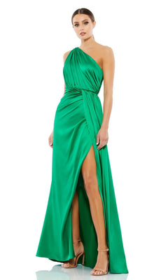 A woman wearing the Mac Duggal 26654 one-shoulder, floor-length emerald satin formal dress with a high slit and nude heels stands against a plain white background.