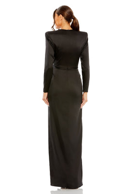 A woman with her hair in a low ponytail is seen from the back, wearing the floor-length black Mac Duggal 26676 Bold-Shoulder Long Formal Dress, featuring bra-friendly long sleeves.