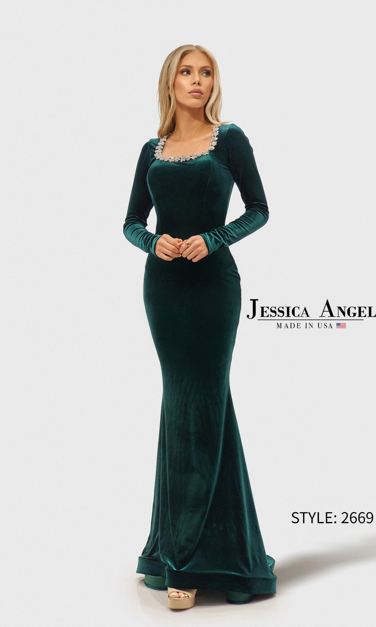 A woman wearing the Jessica Angel 2669 Long Prom Dress—a floor-length, long-sleeve velvet dress in hunter green with a square neckline and embellished trim.