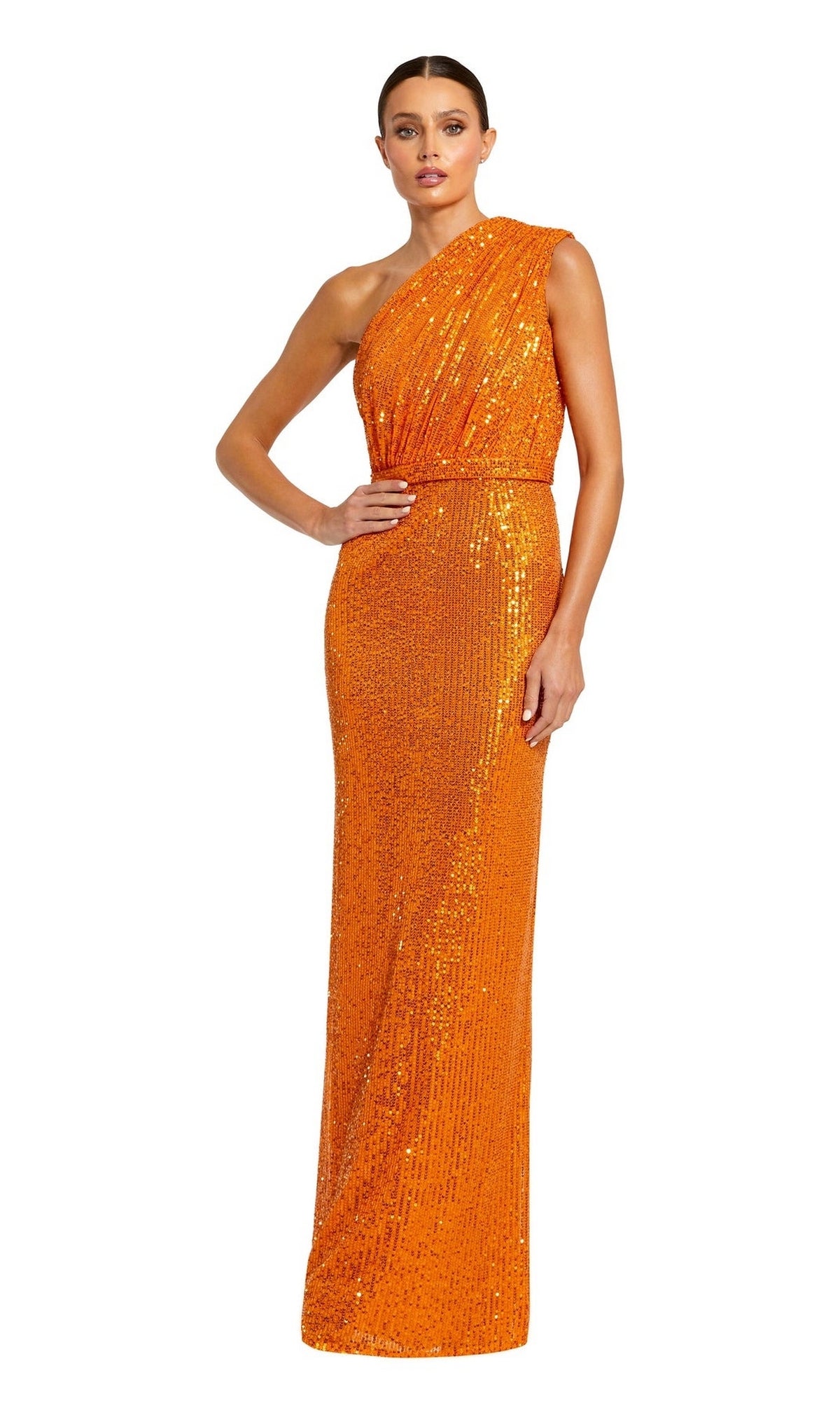 A woman poses with one hand on her hip against a white background, wearing the floor-length, sequin Mac Duggal 26694 One-Shoulder Long Formal Dress in bright orange, shimmering elegantly for any evening event.