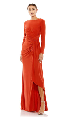 A woman poses in strappy heels against a white backdrop, wearing the Long Formal Dress 26714 by Mac Duggal—a floor-length gown with long sleeves, draped waist detailing, and a side slit for added elegance.
