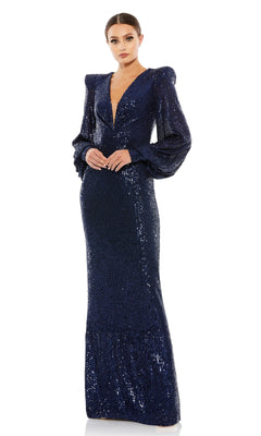 A woman wears the Mac Duggal Long Formal Dress 26722 in navy blue, featuring sequins, a deep v-neckline, puffed shoulders, and long sleeves against a white background.