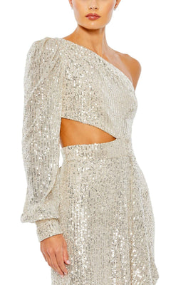 A woman wears the Mac Duggal 26730 Cut-Out Long Sequin Formal Dress, a shimmering silver one-sleeve gown with striking waist cutout.