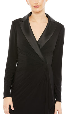 A woman wearing the Long Formal Dress 26731 by Mac Duggal, a floor-length black gown featuring long sleeves, a collared satin lapel, and a deep V-neckline.