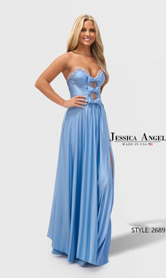 A woman stands and smiles against a plain background, wearing the Long Prom Dress: Jessica Angel 2689 in Copen, featuring a strapless neckline, cut-out details, and a thigh-high slit.
