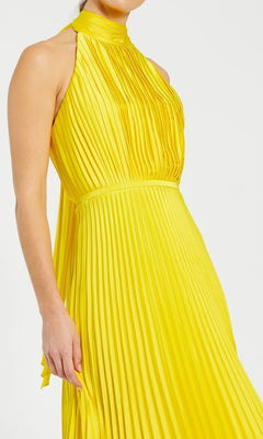 A person models the Tea Length Formal Dress 26909 by Mac Duggal in yellow, featuring a sleeveless, pleated design and high neckline, shown from shoulders to mid-thigh against a plain background.