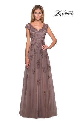 A woman stands against a white background wearing the La Femme 26942, a mauve floor-length formal dress featuring floral lace, cap sleeves, and delicate embroidery—an elegant option for a mother-of-the-bride or any sophisticated occasion.