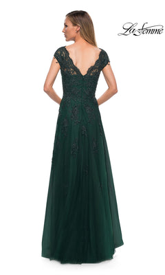 A woman is seen from the back wearing the La Femme 26942 long formal dress in dark green, featuring floor-length design, delicate floral lace details, and cap sleeves, standing against a white background.