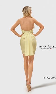 A woman faces away, wearing the Short Prom Dress: Jessica Angel 2695 in light yellow with a sash at the back and beige high-heeled sandals. Text reads "Jessica Angel" and "Style: 2695.