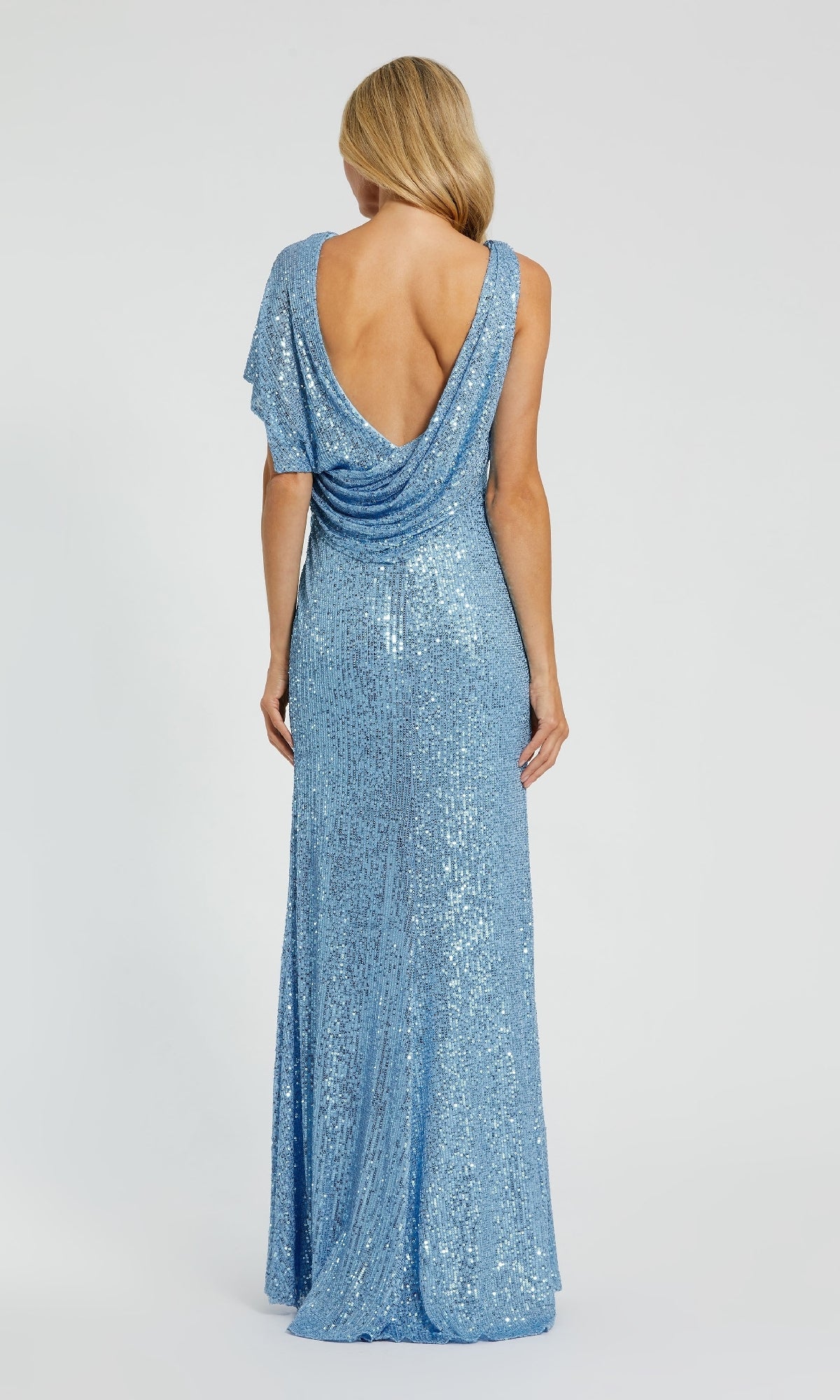 Someone wearing the Long V-Neck Sequin Formal Dress: Mac Duggal 26988, a floor-length light blue gown with sequins and a draped open back, poses against a plain background.