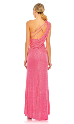 A woman faces away, wearing the Mac Duggal 26990 One-Shoulder Sequin Formal Gown—a long pink dress with draped details, one shoulder design, and two thin straps crossing her elegantly open back.