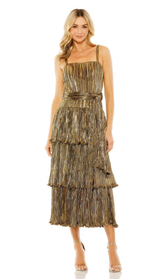 A woman wears the Mac Duggal Tea-Length Metallic Party Dress 27062—a gold, tiered, tea-length cocktail dress with spaghetti straps and a matching waist tie—styled with strappy heels.