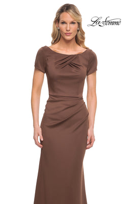 A woman wears the Long Formal Dress: La Femme 27067—a fitted, short-sleeve brown trumpet gown with pleated neckline detail. “La Femme” logo appears in the upper right corner.