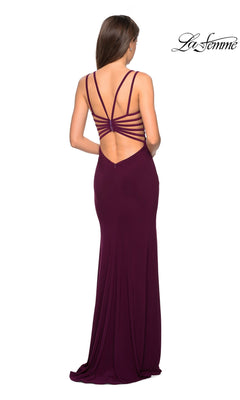 Woman wearing the La Femme Statement-Back Long Prom Dress 27072, a floor-length deep purple gown with a fitted silhouette and an open strappy back, standing and facing away from the camera.