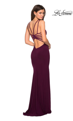 A woman in the La Femme Statement-Back Long Prom Dress 27072, a sleeveless deep purple gown with multiple back straps, stands facing away to highlight its open back. The La Femme logo is displayed in the top right corner.