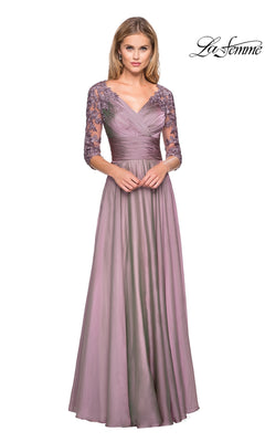 A woman wearing a La Femme 27153 floor-length dusty lilac chiffon formal dress with a V-neckline and three-quarter length lace sleeves, ideal for evening events.