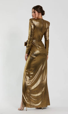 A woman in a long-sleeved Mac Duggal 27206 metallic jersey gown faces away from the camera, glancing over her shoulder against a plain light background.