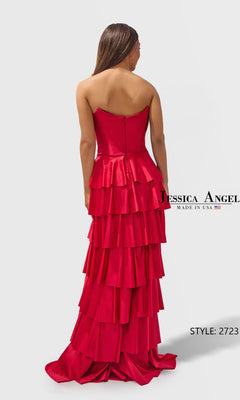 A woman is seen from behind wearing the Jessica Angel 2723 long prom dress, a strapless gown with a bright pink, tiered A-line floor-length skirt.