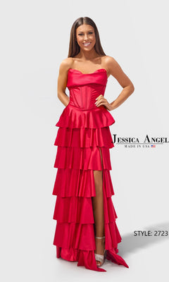 A woman smiles against a light gray background, wearing the Long Prom Dress: Jessica Angel 2723 in Red. The strapless dress features a tiered A-line skirt and thigh-high slit, with "Jessica Angel" and "STYLE: 2723" shown on the image.