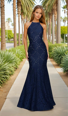Woman wearing a navy blue lace dress standing in front of classical architecture.