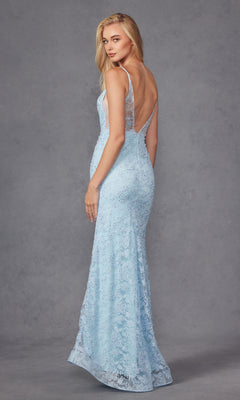 A woman models the Embroidered-Lace Long Beaded Prom Dress 272, featuring a light blue, floor-length backless design with a deep V-back, as she stands against a plain gray background and looks over her shoulder.