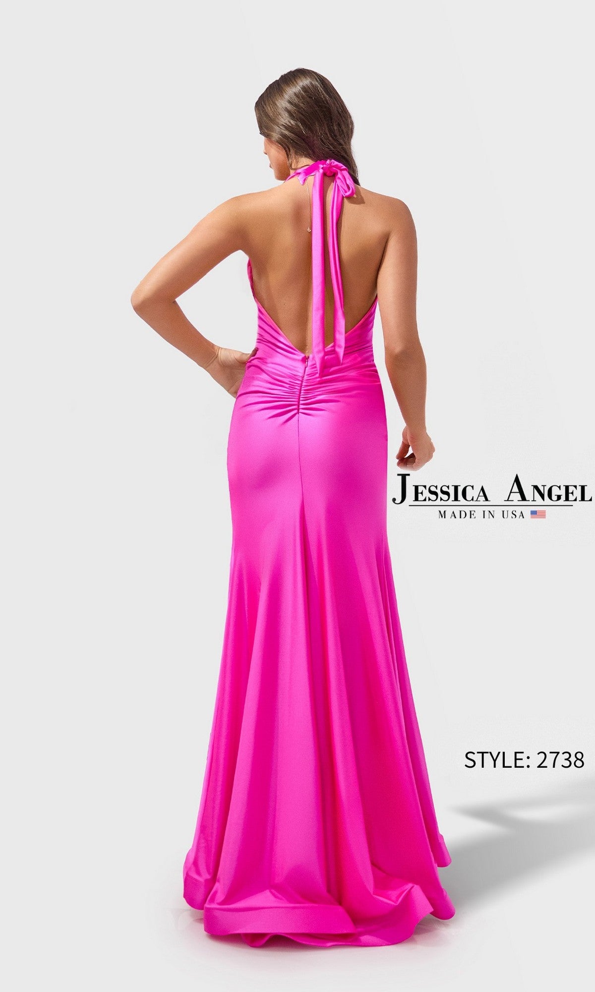 Woman models the Long Prom Dress: Jessica Angel 2738—a vibrant pink halter gown with an open back and floor-length skirt—against a plain white background. 